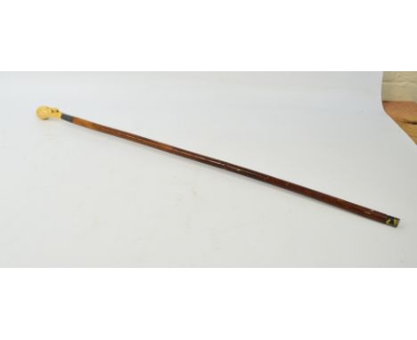 A Japanese ivory handled walking stick carved in the form of a frog on a lily pad, with white metal collar, the cartouche eng