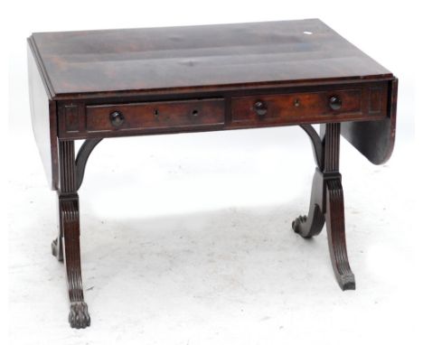 A Georgian mahogany two drawer sofa table, the rounded rectangular top above reeded supports with arched stretcher raised on 