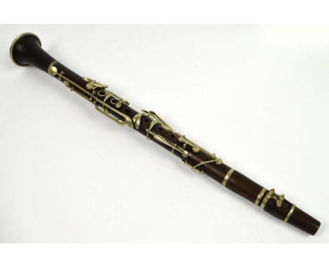 A late 19th/early 20th century rosewood B flat clarinet by JTL, with nickel keys, in ebonised wooden case.