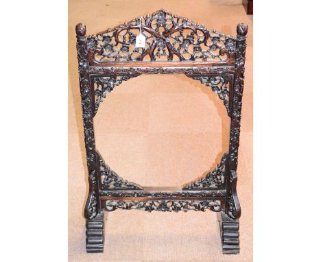 A 19th century Chinese huali wood floor standing gong frame, profusely carved throughout with blossoming prunus, with carved 