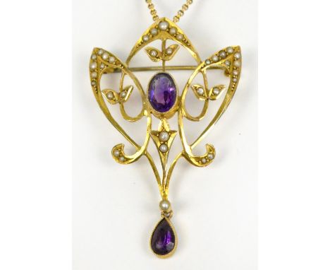 An Edwardian Art Nouveau design 9ct gold pendant set with seed cultured pearls and two amethysts, suspended on a fine link ch