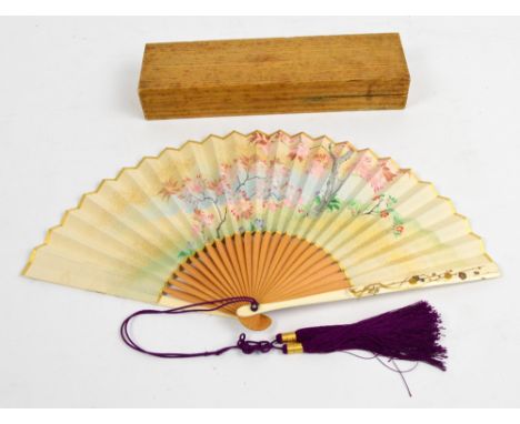 A cased Japanese late Meiji period bamboo, ivory and paper fan, the ivory guard sticks decorated with prunus and birds, the i