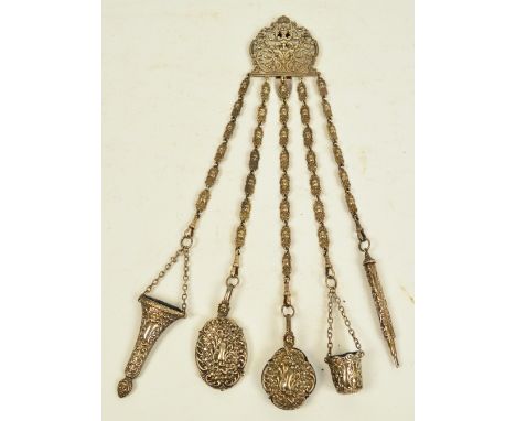 A late 19th century plated chatelaine suspending five implements comprising a thimble case, a propelling pencil, an aide memo