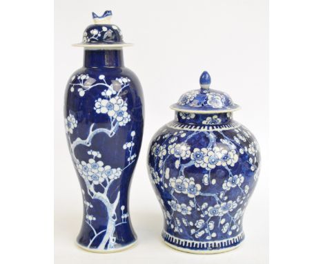 A 19th century Chinese porcelain baluster jar and cover painted in underglaze blue with blossoming prunus, bears underglaze b