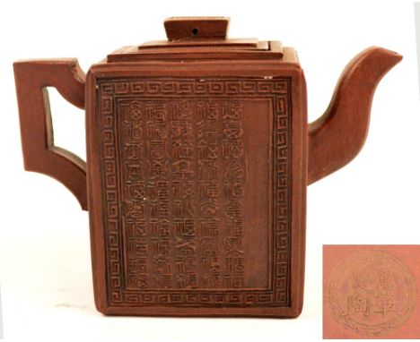 A 19th century Chinese Yixing rectangular teapot decorated to front and back with calligraphy with seal marks, impressed seal