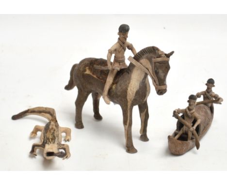 Three small fibre or leather made figures comprising a man on horseback with an axe, a crocodile with a fish in its mouth and