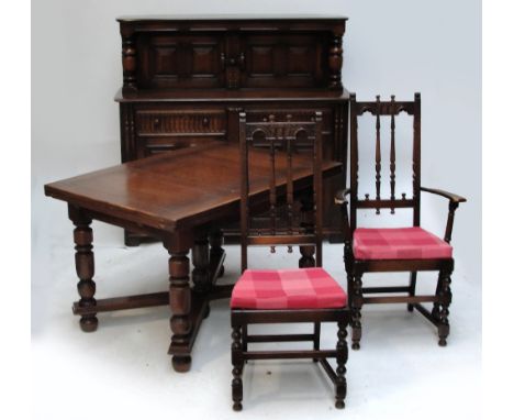 An Ercol oak dining room suite comprising drawleaf table, eight high back chairs (6+2) and a court cupboard (10).