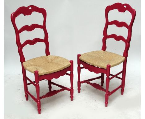 A set of six pink painted wavy ladder back rush seated chairs.