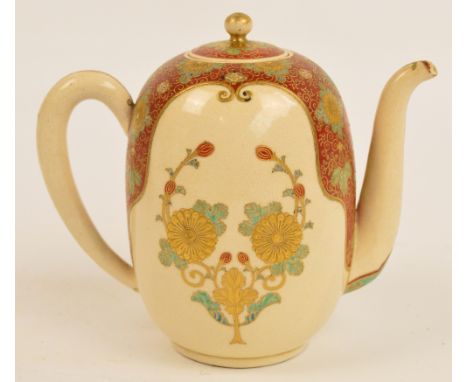 A Japanese Meiji period Satsuma teapot, the angled spout above floral decorated red and cream ground main body with simple lo