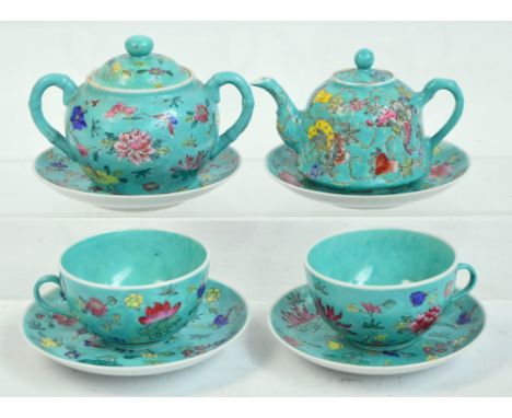 A decorative 20th century Chinese porcelain tea for two set comprising teapot, sugar bowl and stand, two cups and two saucers