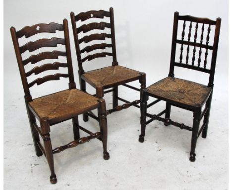 A reproduction set of six ladder back dining chair with rush seats, and a 19th century spindle back rush seated chair (7).