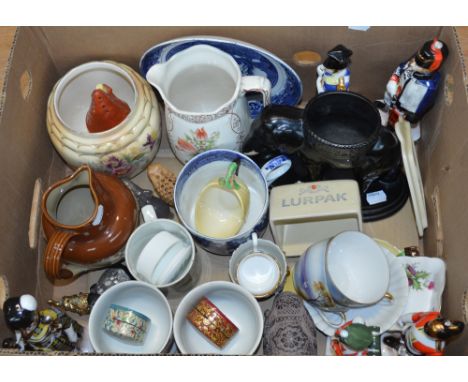 A collection of mixed ceramics to include a Tyke farmer's mug by B & K Ltd, a Carlton Ware sugar sifter in the form of a cott