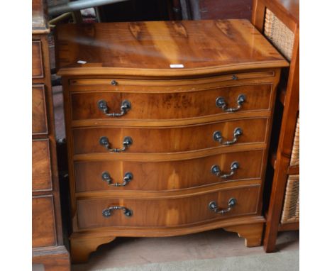 A reproduction yew wood serpentine chest of four graduated drawers raised on bracket feet, width 73cm.