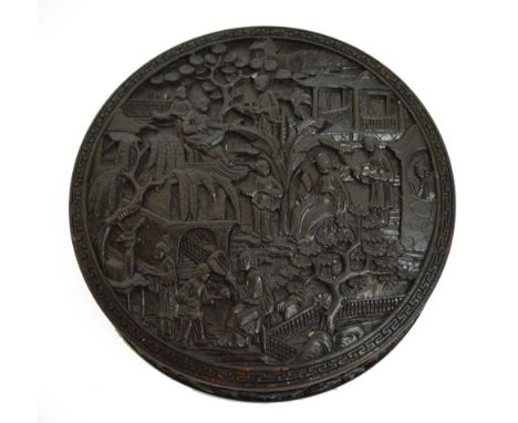 An early 19th century Chinese Canton carved tortoiseshell circular snuff box, the lid finely decorated with figures in a typi