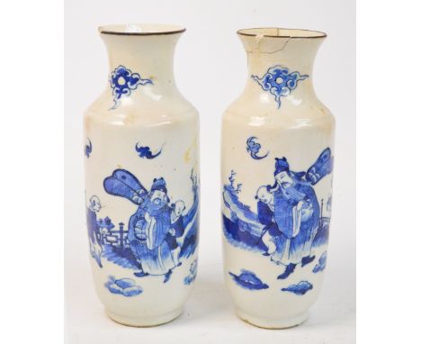 A pair of late 19th century Chinese porcelain baluster vases, each painted in underglaze blue with an official with attendant