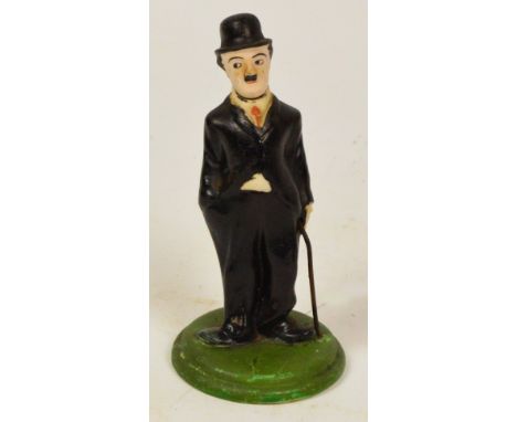 A Wiltshaw & Robinson Carlton Ware bisque porcelain figure of Charlie Chaplin with "nodding head" on elastic pull, black prin