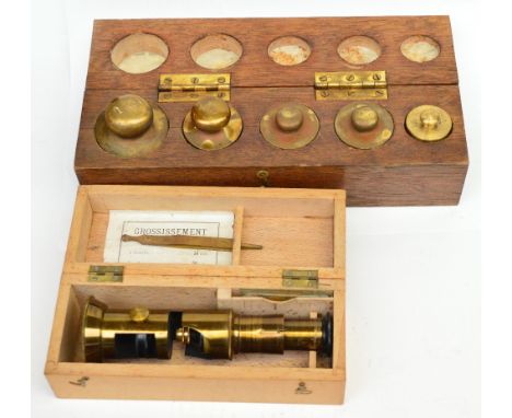 A set of scientific scales, a cased set of graduated brass weights (1kg-100grm), a further set of weights and a boxed student
