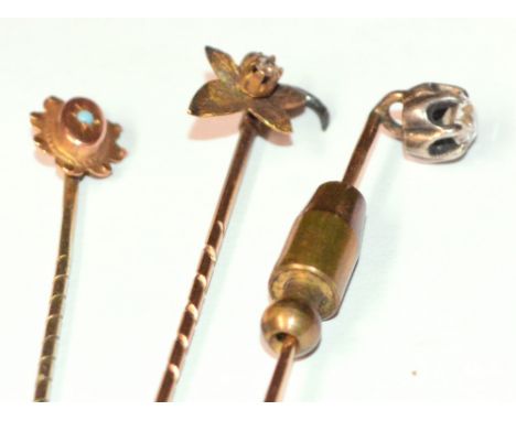 An early 20th century diamond set stick pin, the old cut claw set stone of approx 0.2ct, and two further tie pins (3).