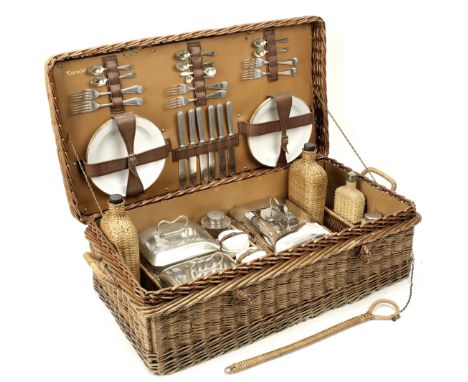 A wicker-cased 'Coracle' picnic set for six persons by G W Scott &amp; Sons, circa 1909,the wicker case with handles and lock