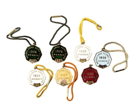 Seven scarce Brooklands Aero Club member's enamel lapel badges 1936-1939,most with cord tie; five by W . O. Lewis (Badges) Lt