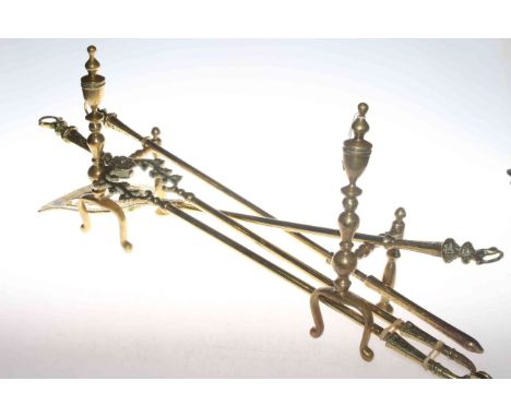 Pair of brass fire dogs with brass fire tools, 65cm.