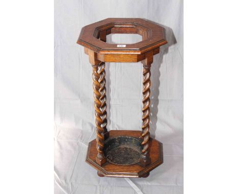 Octagonal oak barley twist stick stand, 67cm by 36cm.