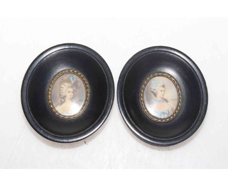 Pair of ebony framed portrait miniatures, signature indistinct. 