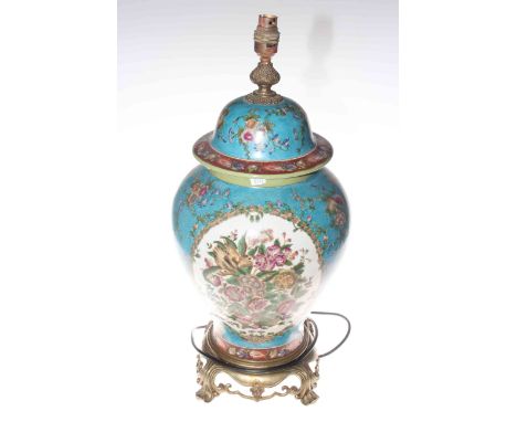 Chinese baluster form table lamp profusely decorated with flowers on mostly blue ground and an ornate gilt metal base, the la