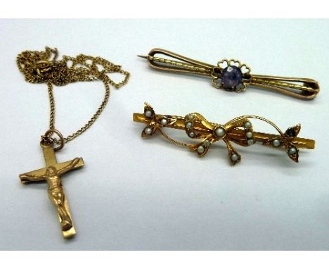 A 9ct gold and seed pearl brooch, a yellow metal and amethyst brooch and a 9ct gold crucifix and chain, total weight 5.7g