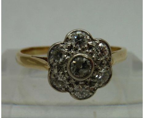 A vintage 18ct gold and platinum diamond daisy cluster ring, weight 2.7g, size R