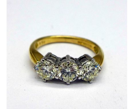 An 18ct gold three stone diamond ring, with diamond certificates, 1.5ct total diamond weight, each stone colour K, clarity SI