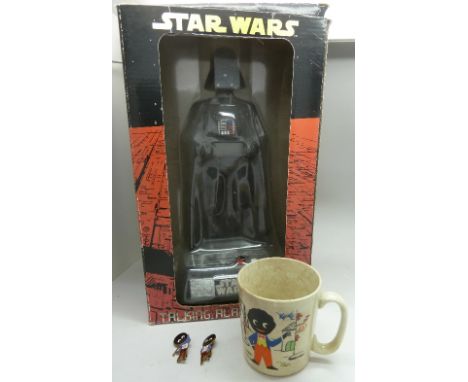 A Star Wars talking alarm clock in the form of Darth Vader and a Robertson's Golly mug with two Golly badges