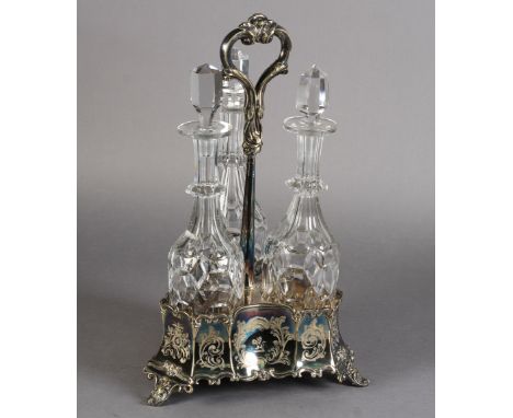 A VICTORIAN 'GOTHIC' PANELLED TREFOIL DECANTER FRAME WITH BOTTLES, the base foliate engraved and with one crest and two vacan