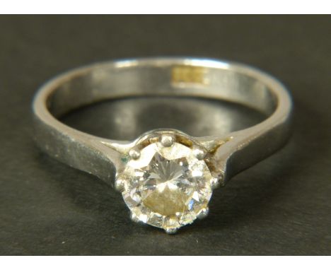 A SINGLE STONE DIAMOND RING in white metal (tests as 18ct gold) the brilliant cut stone crown set with split and tubed should