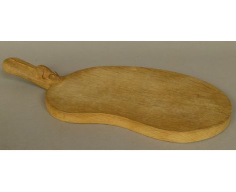 THOMPSON OF KILBURN 'MOUSEMAN', an oak cheese board of slight kidney-shape, carved in relief with a mouse to the handle, 40cm