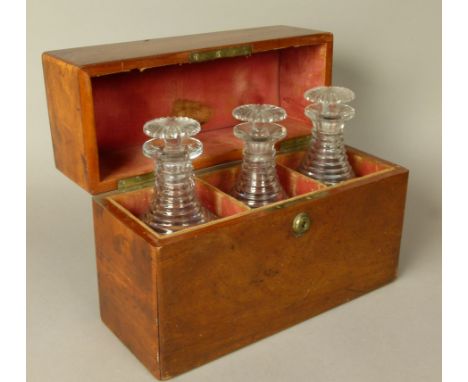 A LATE GEORGE III MAHOGANY DECANTER BOX rectangular, the velvet lined interior fitted with a set of three heavily cut decante