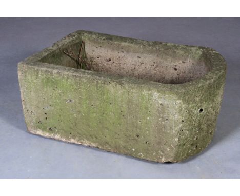 A NATURAL STONE TROUGH, rectangular with a bowed end and drainage hole, 79cm long x 52cm wide x 33cm high. See illustration 