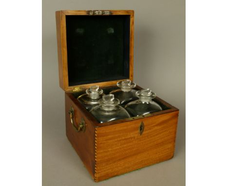 A GEORGE III MAHOGANY DECANTER BOX inlaid in boxwood and ebony chequered banding and with gilt metal side carrying handles, t