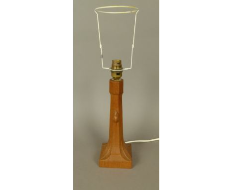 THOMPSON OF KILBURN 'MOUSEMAN' AN OAK TABLE LAMP, the octagonal column terminating in four leaves on a square plinth base and