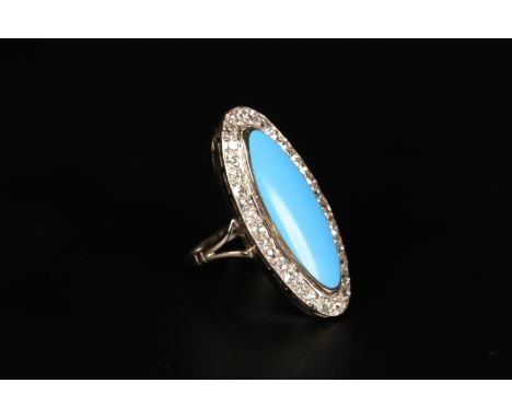 A TURQUOISE AND DIAMOND CLUSTER RING in 18ct white gold c.1950 the turquoise cabochon collet set and raised against a surroun