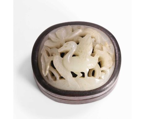 A Chinese jade plaque, Qing dynasty (1644-1911), of oval form, pierced and carved with a goose in a lotus pond, later fixed t