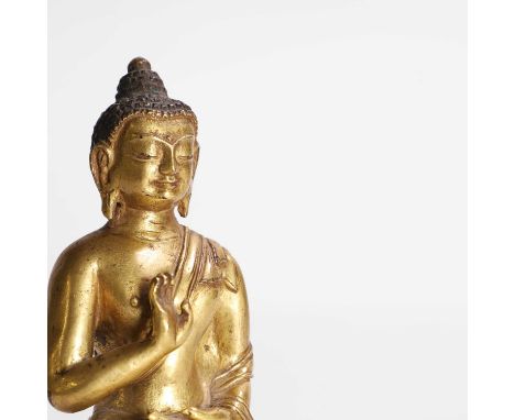 A Tibetan gilt-bronze Buddha, 18th/19th century, seated cross-legged on a double-lotus pedestal, his hands in Vitarka mudra,1