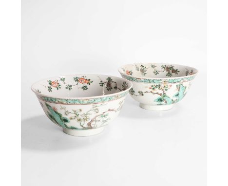 A pair of Chinese famille verte bowls, Kangxi (1662-1722), each with rounded sides rising from a circular foot, painted with 