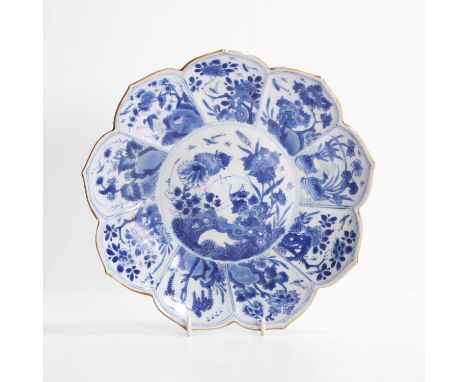 A Chinese blue and white plate, Kangxi (1662-1722), in the shape of a lotus flower, each shaped panel painted with insects, b
