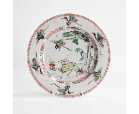 A Chinese wucai plate, Kangxi (1662-1722), of circular form, painted with a deer and lingzhi below a pine tree and a crane, e