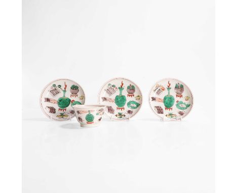 A collection of three Chinese wucai saucers and a cup, Kangxi (1662-1722), each of circular form, painted with precious objec