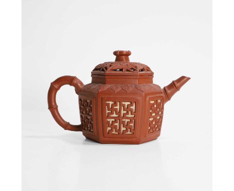 A Chinese Yixing stoneware teapot, Qing dynasty (1644-1911), of hexagonal form, each side carved with four swastika symbols u