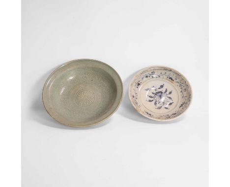 A Thai celadon bowl, the rounded sides rising to a broad rim, the centre decorated with a chrysanthemum roundel, surrounded b