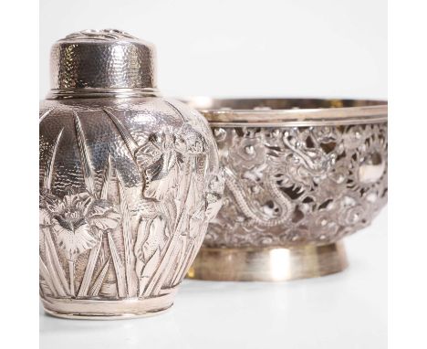 A Japanese silver tea caddy, Meiji period (1868-1912), the ovoid body decorated with irises, stamped marks 'Watanabe' and 'ju