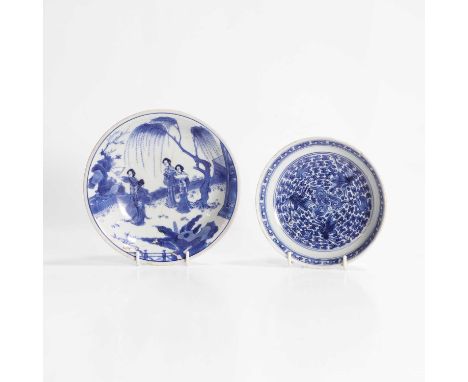 A Chinese blue and white dish, Kangxi (1662-1722), heavily potted, the rounded sides rising from a circular foot to a flared 